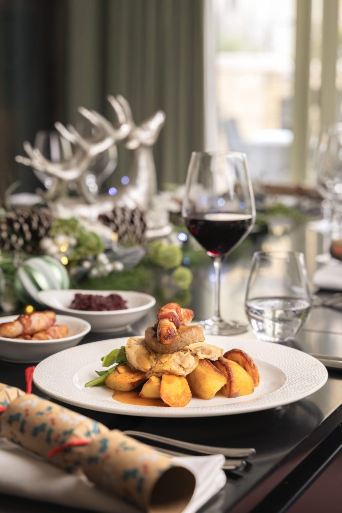 Elegant festive restaurant table setting with fine dining plates, hospitality photographer Lou Carruthers UK
