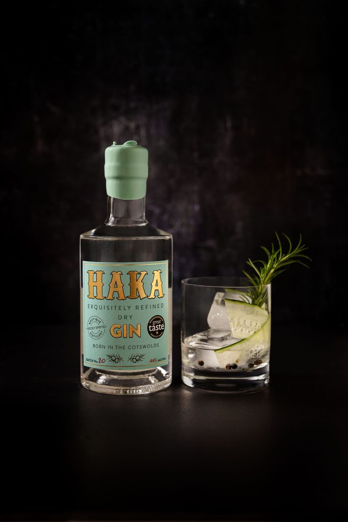 HAKA Gin bottle with served cocktail and fresh cucumber garnish on dark background - Cotswolds craft spirits photography - Lou Carruthers Photography