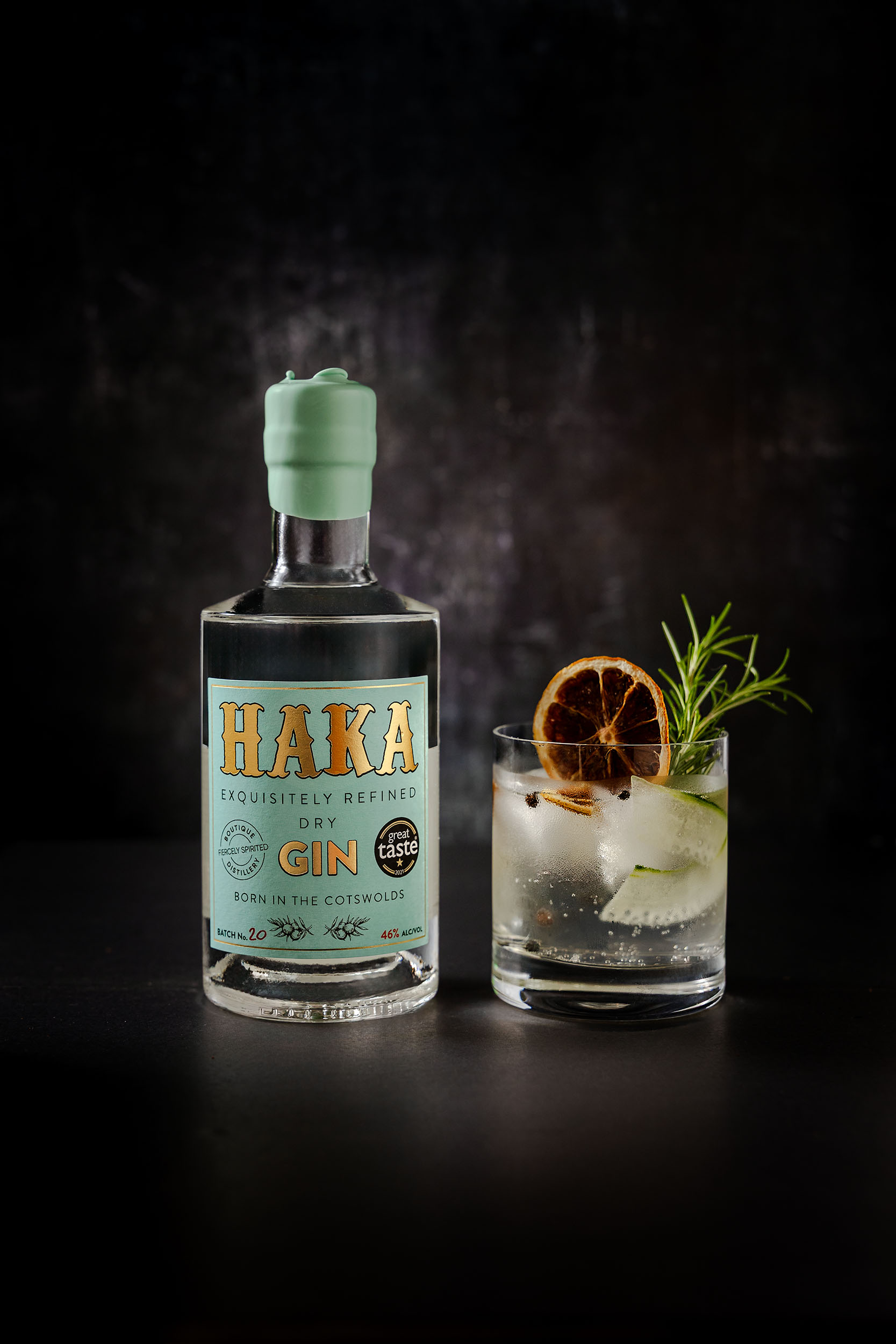 HAKA Gin bottle with styled cocktail featuring dried orange wheel and fresh rosemary - premium spirits product photography - Lou Carruthers Photography