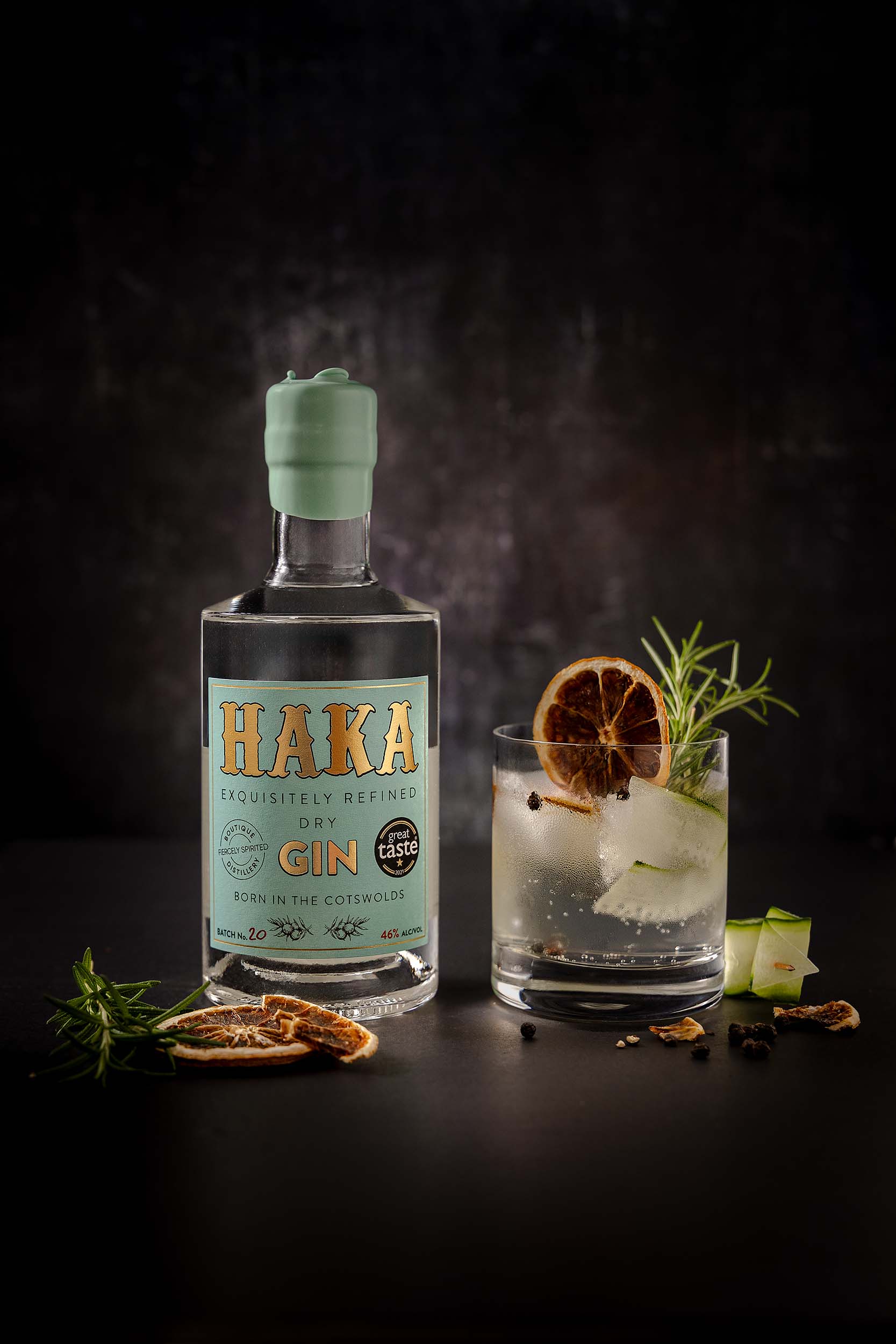 HAKA Gin bottle with cocktail and botanicals — dried orange, rosemary and juniper — craft spirits photography by Lou Carruthers