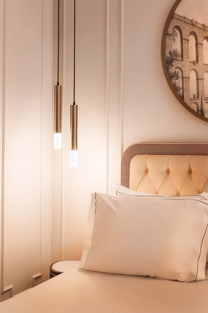 Softly lit hotel room details at H10 Palazzo Galla in Italy, featuring upholstered headboard, crisp white linens and warm brass pendant lighting, photographed by Lou Carruthers, Lou Carruthers Photography, Hospitality & Drinks Photographer, Cotswolds and Menorca
